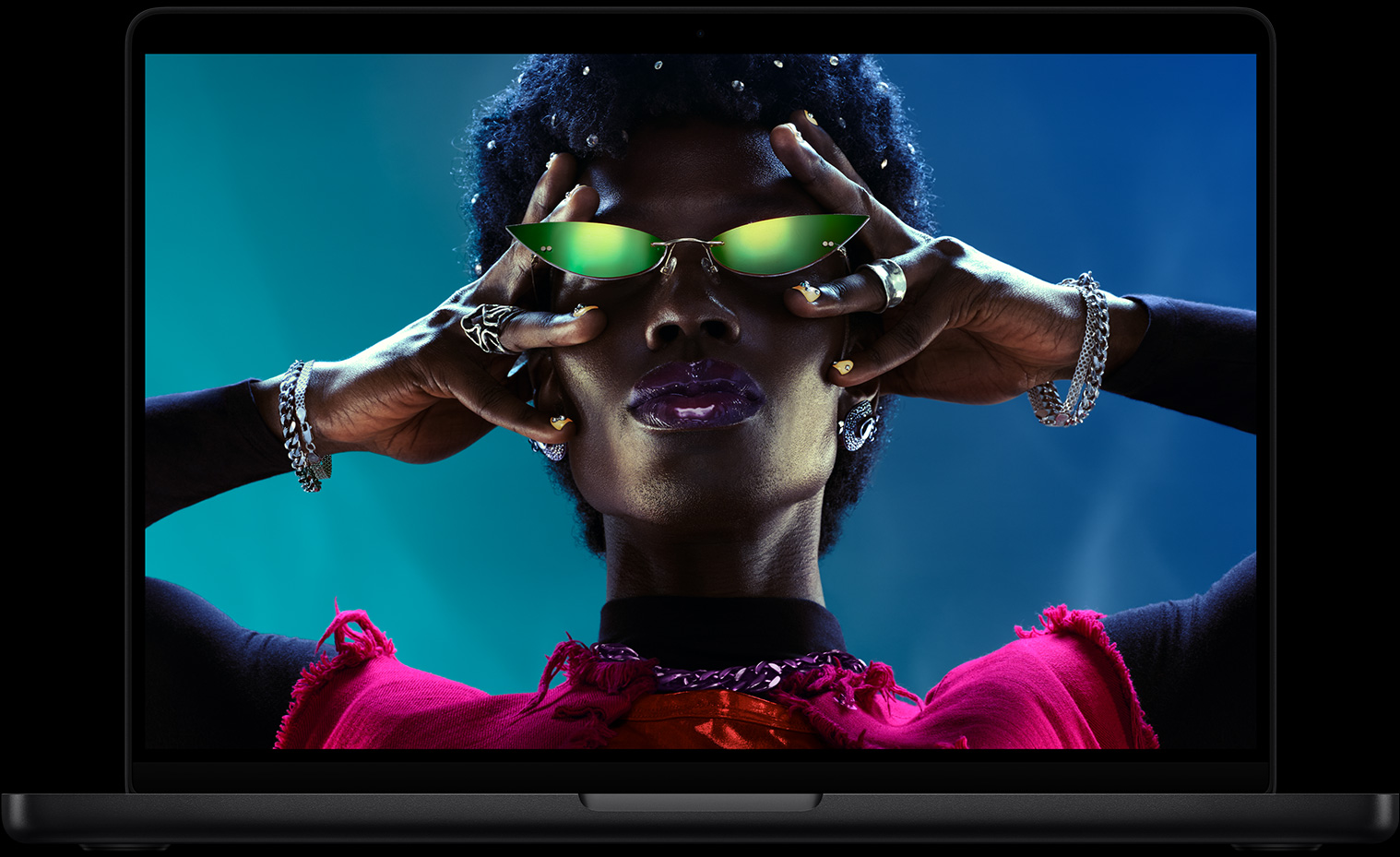 Layar penuh warna pada MacBook Pro memperlihatkan seseorang yang sedang crowdsurfing di pesta, menampilkan layar Liquid Retina XDR yang cemerlang