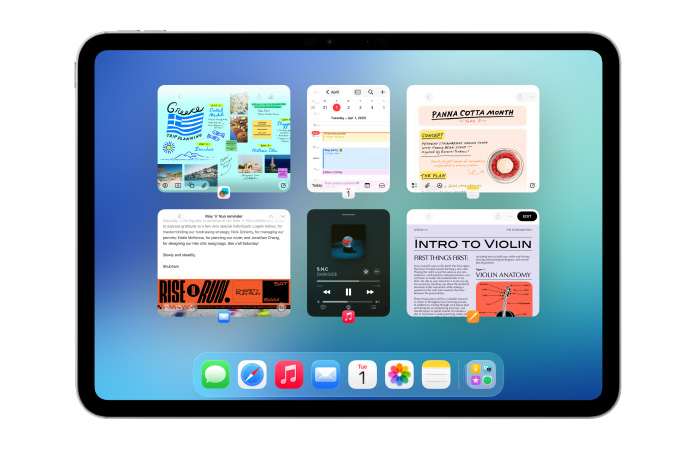 iPad, orientasi lanskap, layar menampilkan beberapa aplikasi seperti Kalender dan Musik dalam enam jendela berukuran sama yang berderet dalam dua baris