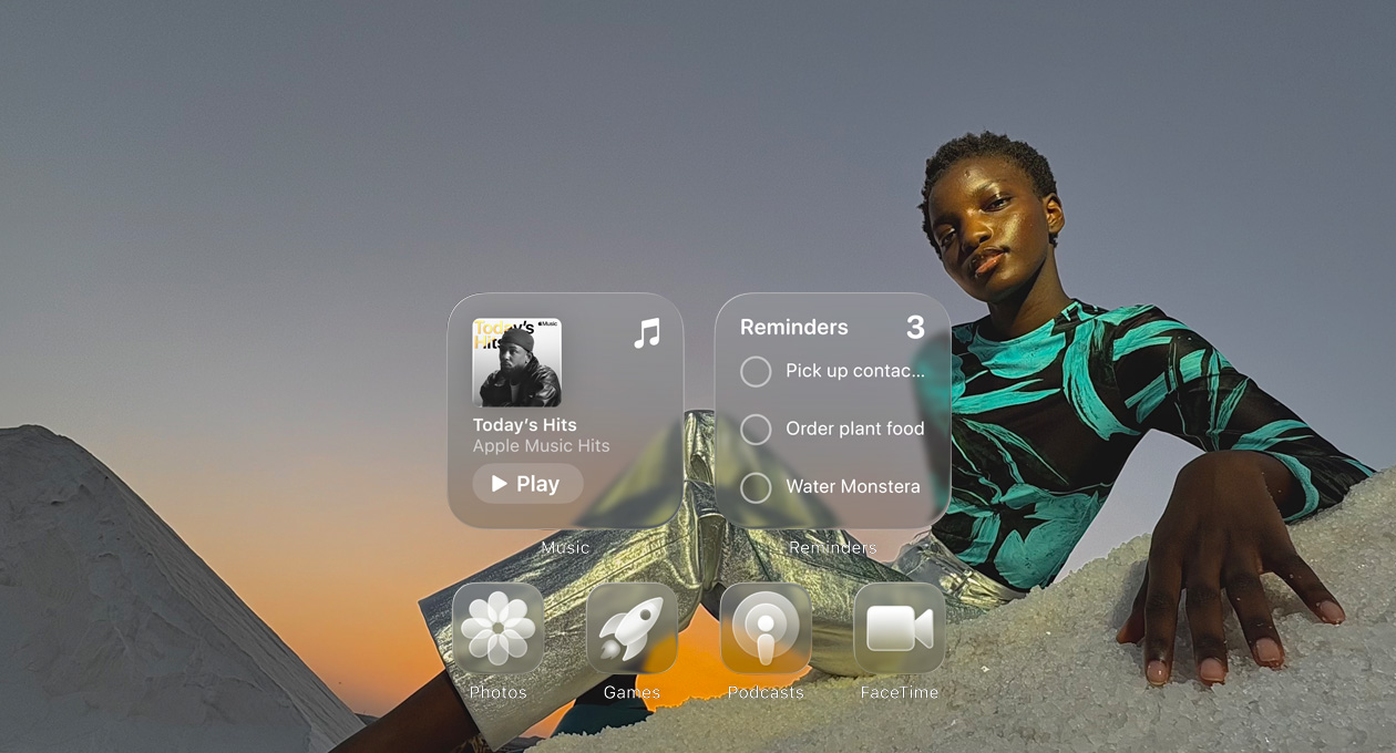 Liquid Glass display with clear app icons, like Apple Music, Reminders, Photos, Games, Podcasts, and FaceTime refracting against the wallpaper
