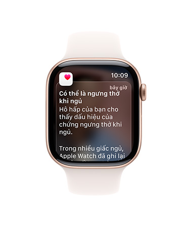 Apple Watch Series 11, rose gold color, aluminum case, expanded sleep apnea notification, right side exterior, Digital Crown, Sport Band, light blush color